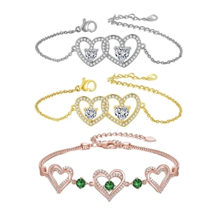 Detailed view of heart-shaped bracelets in silver, gold, and rose gold with zircon stones