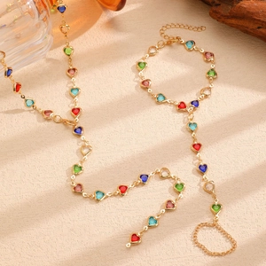 Artistic close-up of colorful heart gem jewelry set with necklace and slave bracelet