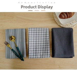 Detailed texture of grey waffle weave cotton tea towels in striped and solid patterns