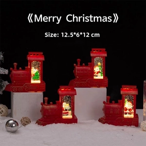 Detail of red Christmas train snow globe with Santa and tree, measuring 12.5x6x12cm