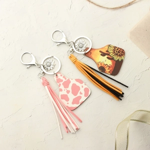 Western style sunflower keychain with cow print tags and colorful faux suede tassels