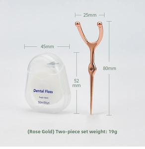 Macro view of portable rose gold stainless steel dental floss holder and 50m mint floss box