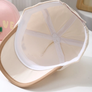 Detail view of the six-panel interior stitching and mesh lining of toddler baseball cap