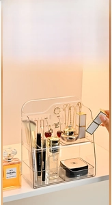 Macro detail of a 2-tier transparent PET vanity organizer with hooks for jewelry storage
