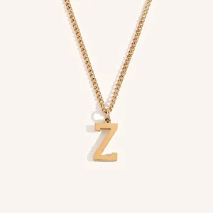 Detail showing gold 18k plated letter Z pendant with polished surface and link chain