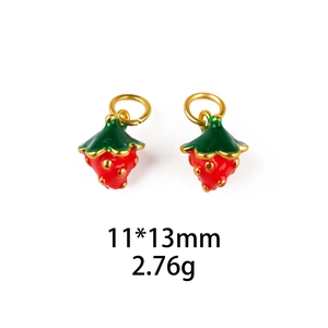 Detail view of two red enamel strawberry charms with gold seeds and size specs