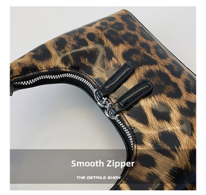 Detailed close-up of glossy leopard print patent leather with high-quality dual zippers