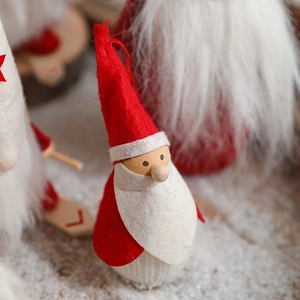 Standing Santa Claus doll in felt and wood for cozy Christmas window decoration