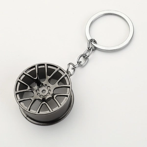 Car wheel rim keychain in gunmetal finish made of premium metal with flat white background