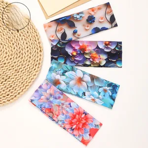 Detailed view of four floral print headbands featuring 3D visual patterns on a natural background
