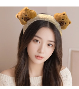 Detail of plush brown Capybara headband on model, soft fuzzy texture hair accessory