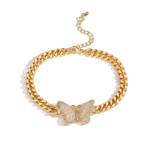 Chic gold-plated Cuban chain bracelet with crystal butterfly and star charms on white background