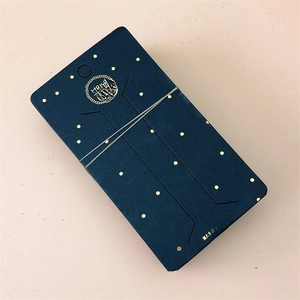 Detail of dark blue jewelry display cards with gold dots and Hand Made logo