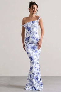 Detail showing blue floral patterns and asymmetrical one-shoulder cut on white dress