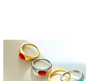 Macro detail of vintage signet rings with oval red and green stones in gold and silver