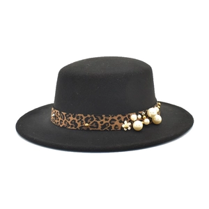 Détail du chapeau noir en laine avec ruban léopard orné de perles et de clous dorés