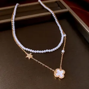 Double-layer pearl and gold chain necklace with star and clover flower pendants