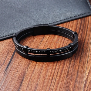 Detailed view of men's multi-layer black leather woven bracelet with metal magnetic clasp