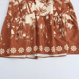 Tropical coconut tree print maxi dress featuring a halter neck and brown palm tree pattern