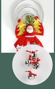 Close-up of metallic silver bells and festive red Santa ornament on Christmas pendant
