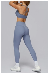 Detail view of the smog blue cross-back sports bra and high-waisted seamless yoga leggings