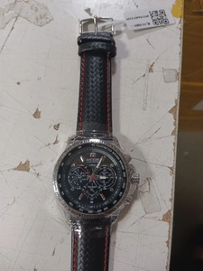 Detailed view of Megir sports watch with chronograph sub-dials and red stitched leather strap