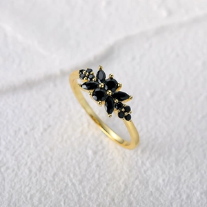 Macro view of marquise cut black zircon cluster in vintage gold plated silver ring