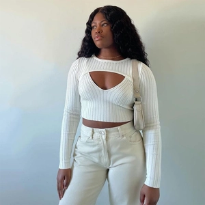 Detail of white ribbed knit cropped top featuring stylish front cut-out and V-neckline
