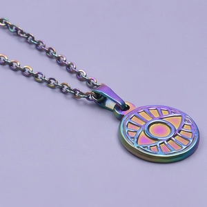 Macro shot of colorful iridescent evil eye pendant on stainless steel necklace chain