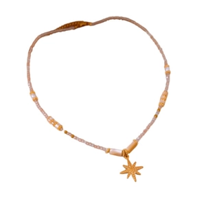 Pink and white beaded necklace with gold star pendant on a minimalist white background
