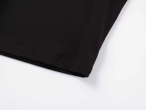 Detail of premium black modal t-shirt showing fine double-needle stitching and fabric texture