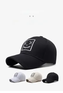 Close-up of baseball cap with graffiti style embroidery in black, white and beige colors