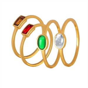 Set of four minimalist gold-plated rings featuring colorful rectangle and oval gemstones