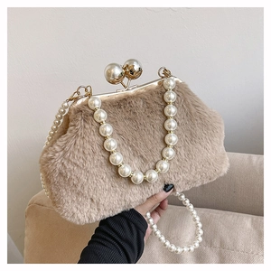 Detail of plush leopard print handbag featuring double pearl chain handles and gold clasp