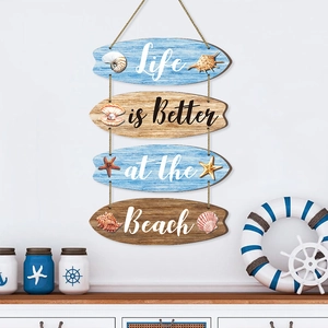 Coastal wooden surfboard wall hanging with shells and Life is Better at the Beach text
