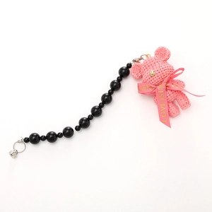 Pink knitted bear keychain with a Love Is ribbon and gradient black beads chain