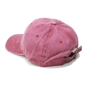 Detail of vintage magenta cotton baseball cap showing adjustable metal buckle and stitching