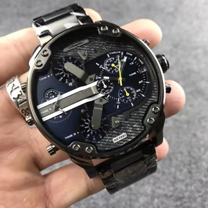 Macro shot of oversized black stainless steel watch dial showing four time zones and dates