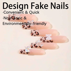 Long nude press-on nails with leopard print tips and 3D bow accents in a glossy finish