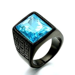 Macro detail of men's black stainless steel ring with square blue gemstone and Greek key