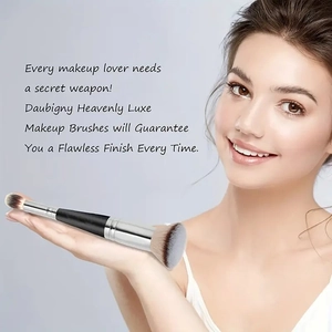 Dual-ended makeup brush with black handle and silver ferrule held by a model