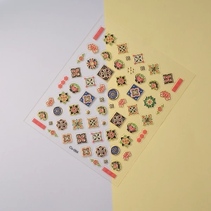 Close-up of Bohemian 5D embossed nail stickers with gold foil geometric floral patterns
