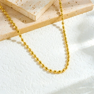 Chic gold-plated stainless steel rugby bead necklace on a minimalist stone display