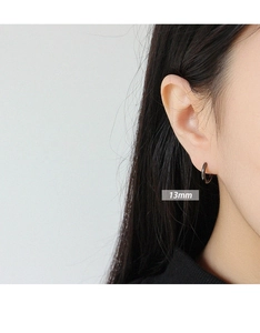 Detail shot of a 13mm minimalist black geometric hoop earring worn by a model