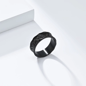 Macro view of matte black Eye of Horus titanium ring with engraved geometric patterns