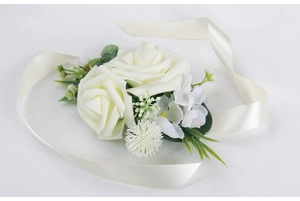 Detailed view of cream artificial roses and ribbon for bridal wrist corsage accessories
