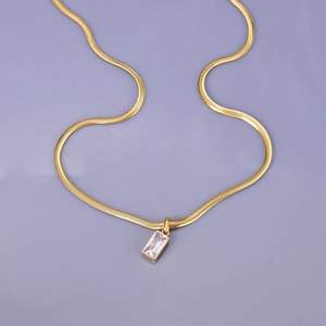 Gold snake chain necklace with a rectangular clear emerald-cut crystal pendant