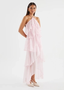 Close-up of the light pink multi-layered ruffled tiers on this elegant halter maxi dress