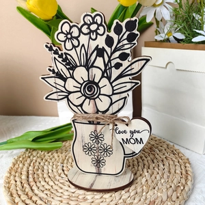 Detail view of laser-cut wooden flower mug ornament with Love You Mom heart tag