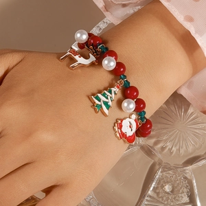 Detailed view of a Christmas beaded bracelet featuring Santa, reindeer, and tree charms